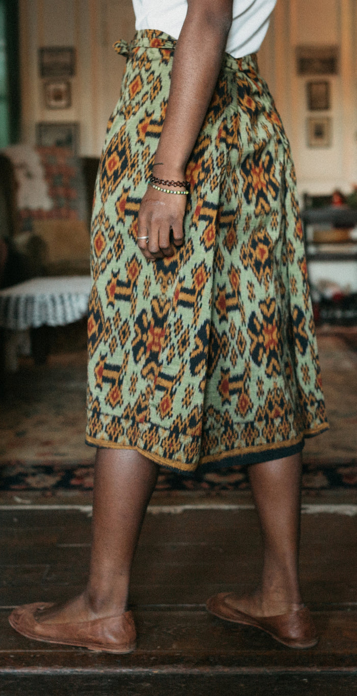 Mid calf version of chupa inspired wrap skirt. Shows wrapping side extensions.