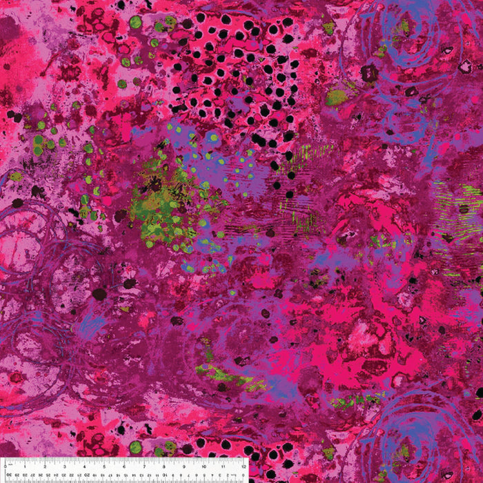 Colorful abstract pattern with pink, purple, and green colors on a fabric with a ruler for scale on the bottom.