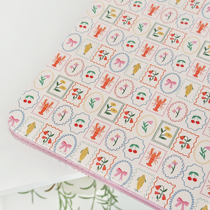 Dolce Vita iPad case in vegan leather with colorful prints of lobsters, dragonflies, flowers, and seashells.