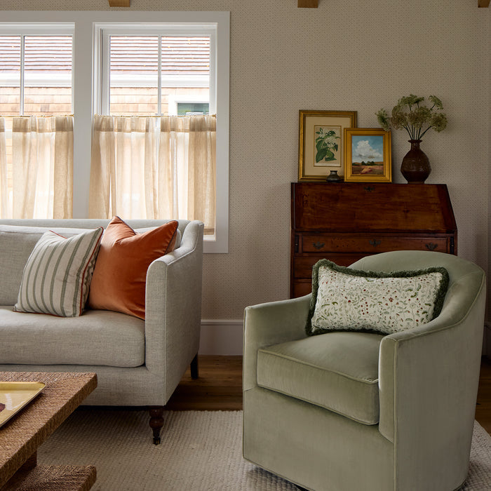 Goldie Stone wallpaper in soft neutral tones with subtle textured pattern, complementing a cozy, warm living room setting.