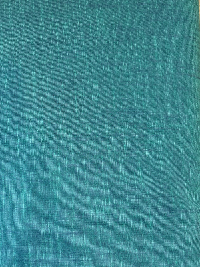 Handloom cotton fabric in a teal color.