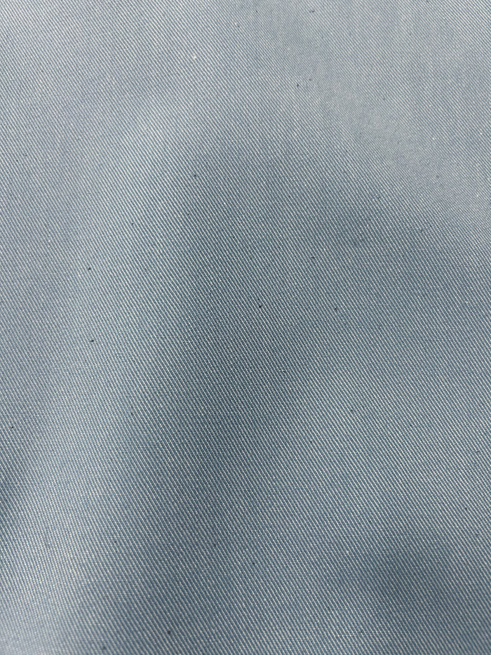Close up of pale blue light wash denim fabric.