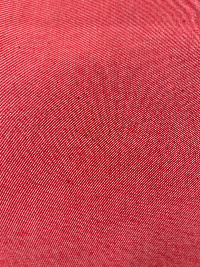 Close-up of bright red cotton denim fabric.