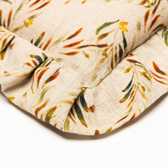 Close view of the ruffled corner and linen fabric on the Red Palm Organic Linen Ruffled Pillow Cover