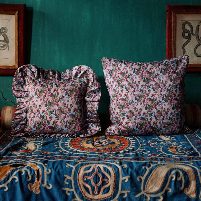 Styled view of the Romance Is Dead Organic Cotton Ruffled Pillow Cover in Blue