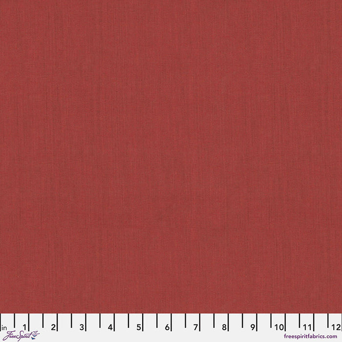 Solid rusty red fabric swatch with a ruler at the bottom