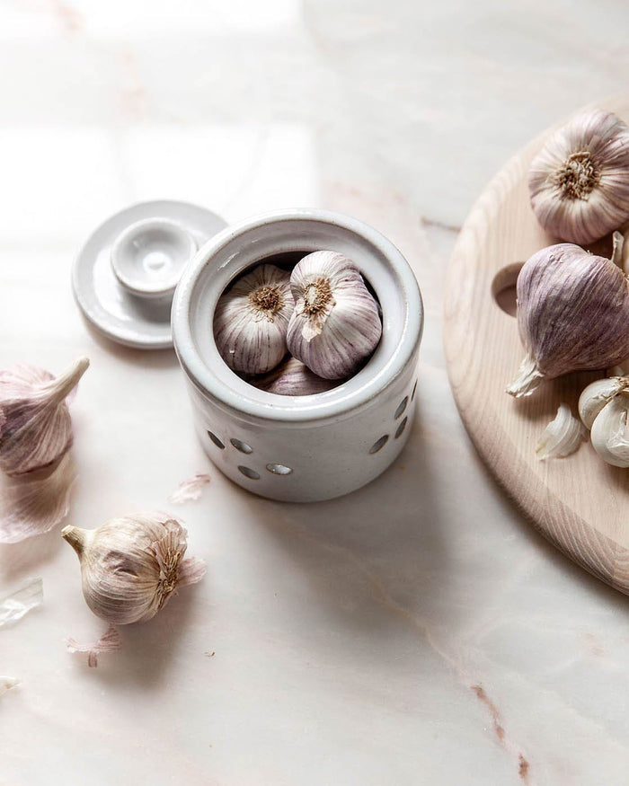 Silo Stoneware Garlic Keeper — keeper beside loose garlic bulbs; Farmhouse Pottery