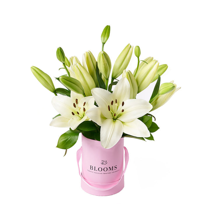 White Lilies Bouquet Presented in Tall Pink Hat Box – gift basket with this beautiful arrangement features a selection of lilies