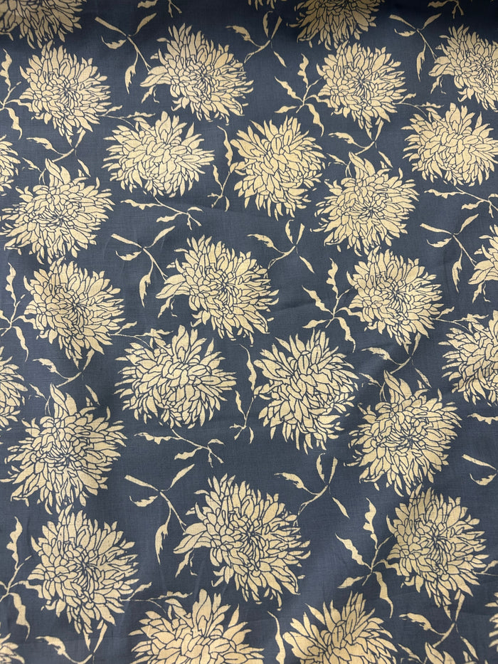 floral print fabric with off white peonies on a dark blue background.