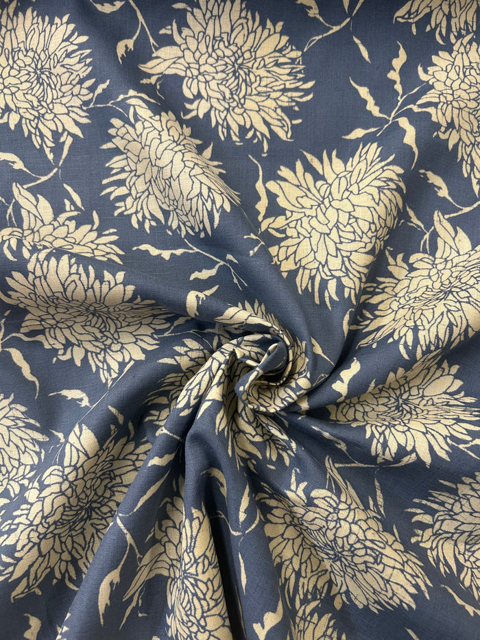 floral print fabric with off white peonies on a dark blue background in a swirl.