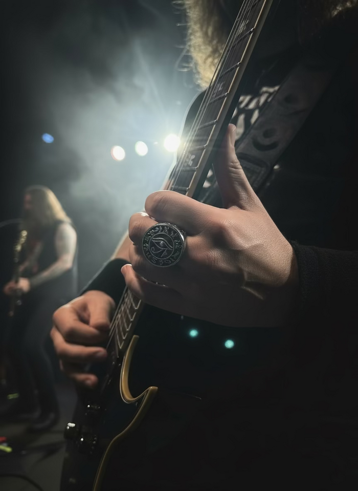 Eye of Horus Ring on a guitarist's middle finger