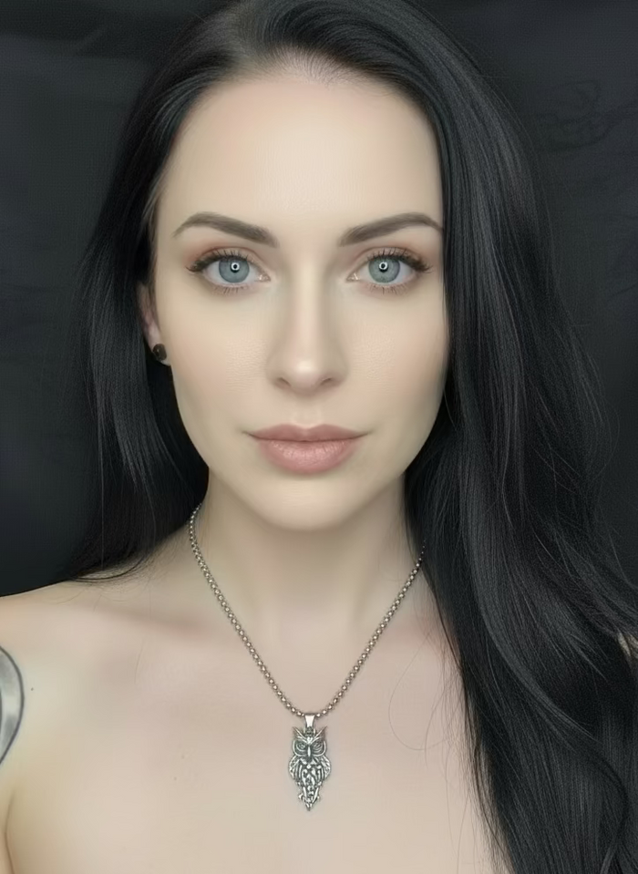 Woman wearing a necklace with the Great Horned 6 knot Ancient Tribal owl pendant against a black background