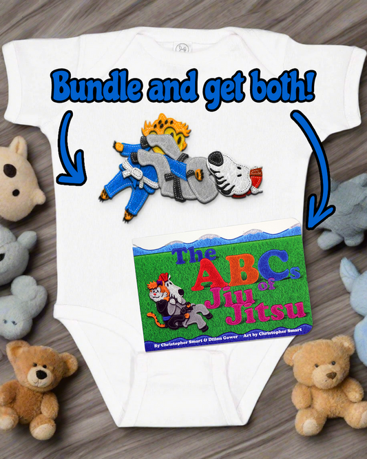 The Retro Grappler ABCs of Jiu Jitsu New Parent Bundle includes a cute white onesie featuring a cartoon lion and dog doing jiu jitsu, plus the colorful ABCs of Jiu Jitsu board book—an adorable baby gift set!.