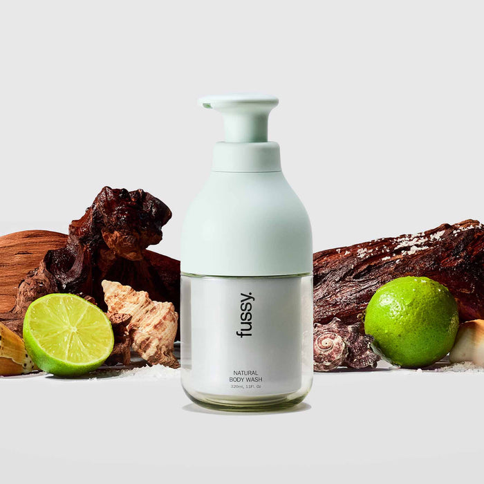 Fussy's All At Sea Body Wash Starter Pack with Lime Green refillable bottle, set against a backdrop of cedarwood, limes and sea shells.