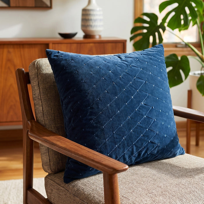 Aviana velvet pillow in dark blue, lifestyle room setting on sofa