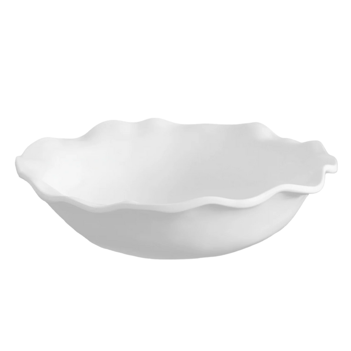White ceramic bowl with scalloped edge on a white background