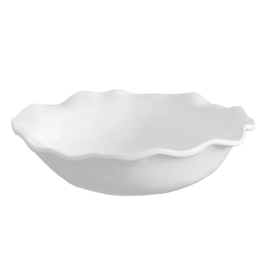 White ceramic bowl with scalloped edge on a white background