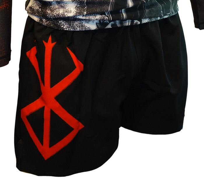 The Retro Grappler Berserk Lightweight BJJ Shorts are black with a bold red rune design on the left leg. Shown worn by a standing model, they offer added comfort with no Velcro and pair well with an athletic black-and-white shirt.