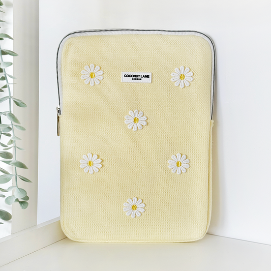 Yellow padded iPad sleeve with white embroidered daisy pattern by Coconut Lane.