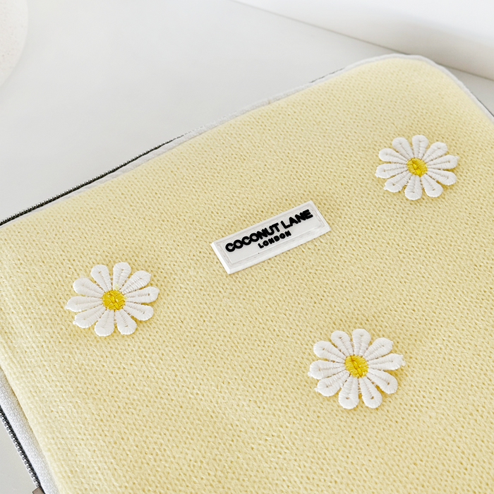 Yellow iPad sleeve with textured floral design, three white daisies, and Coconut Lane logo at the top.