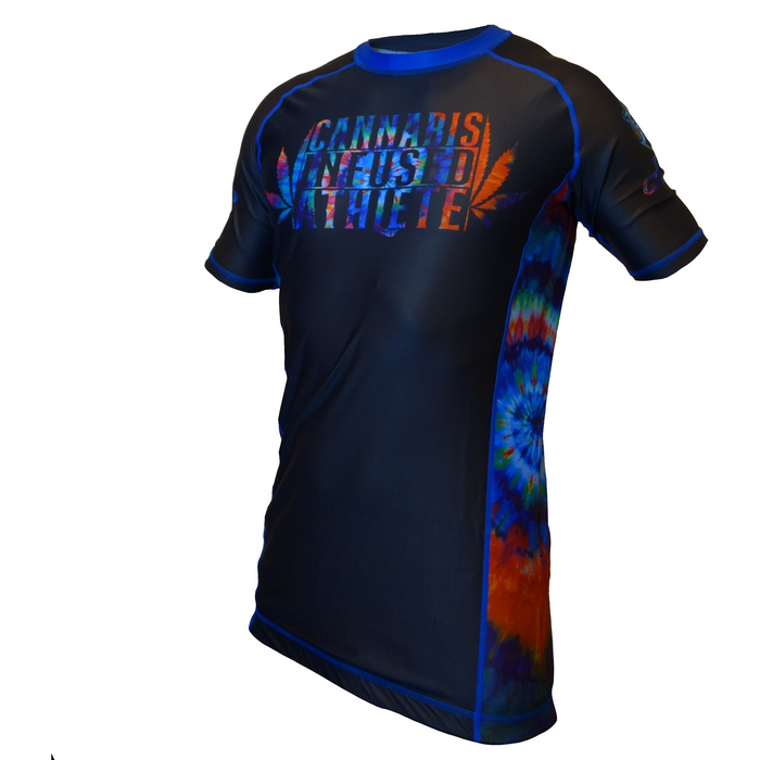 The Retro Grappler  Cannabis Infused Rash Guard Athlete Tie Dye Series 1 is a short-sleeve black rashguard with blue trim, tie-dye graphics, and “Cannabis Infused Athlete” in colorful text. Part of the Submission Grappling Series.