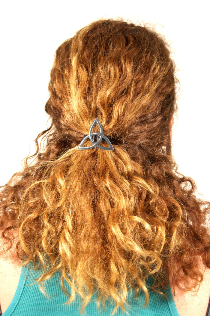 Silver Celtic eternity knot hair hook worn in curly red hair, back view