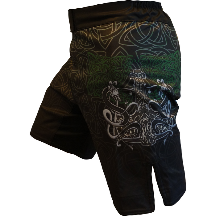 The Retro Grappler Celtic Luck Fight Short is a black athletic short with green and silver trinity knot designs and a bold Mjölnir (Thors Hammer) graphic on the side.