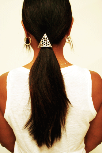 Silver Celtic triangle hair hook ponytail holder with trinity knot design worn in long dark ponytail, back view