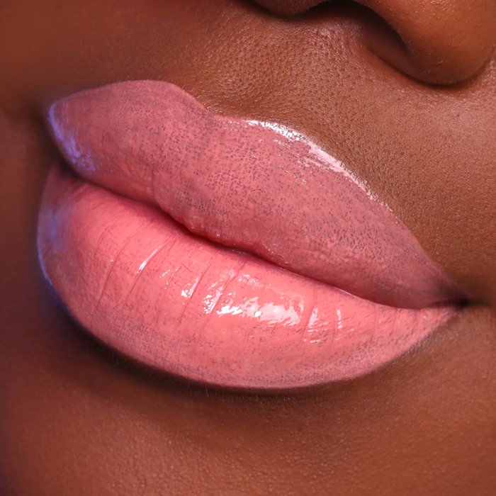 City Girl coral nude lip gloss on lips, deep skin tone close-up