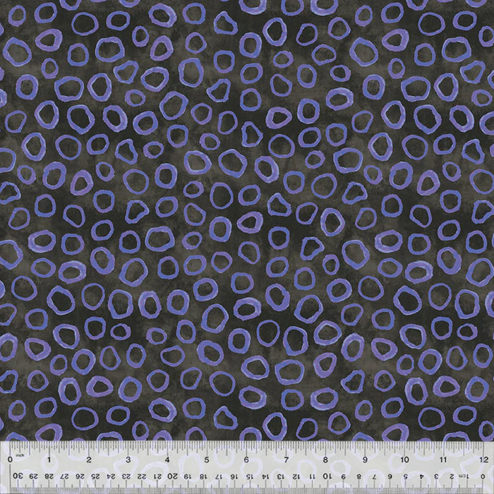 Purple abstract circle pattern on black fabric with a ruler at the bottom.