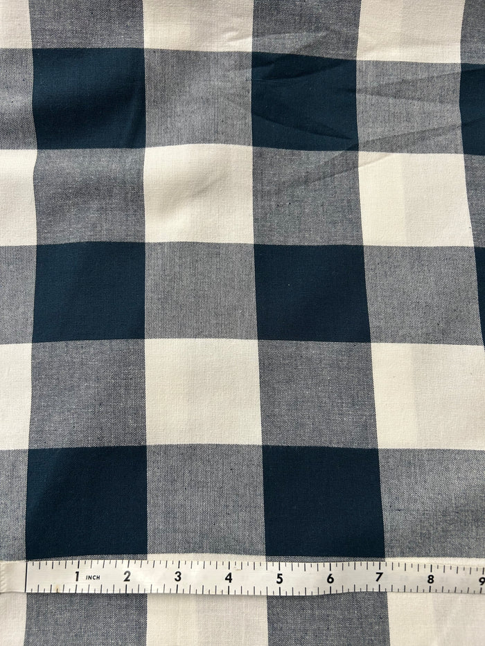 Navy and white checkered gingham fabric with a ruler for scale