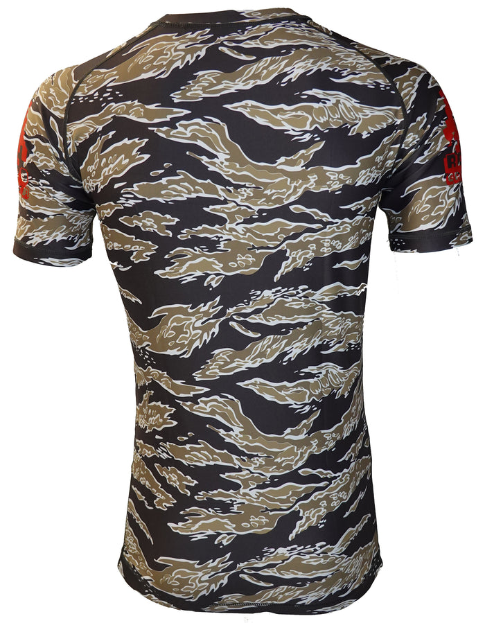The Retro Grappler Cuddle Time Tiger Stripe Camo Rash Guard features brown, black, and gray tiger-stripe camo with red sleeve text—ideal as a stylish short-sleeve BJJ rash guard for jiu jitsu training.