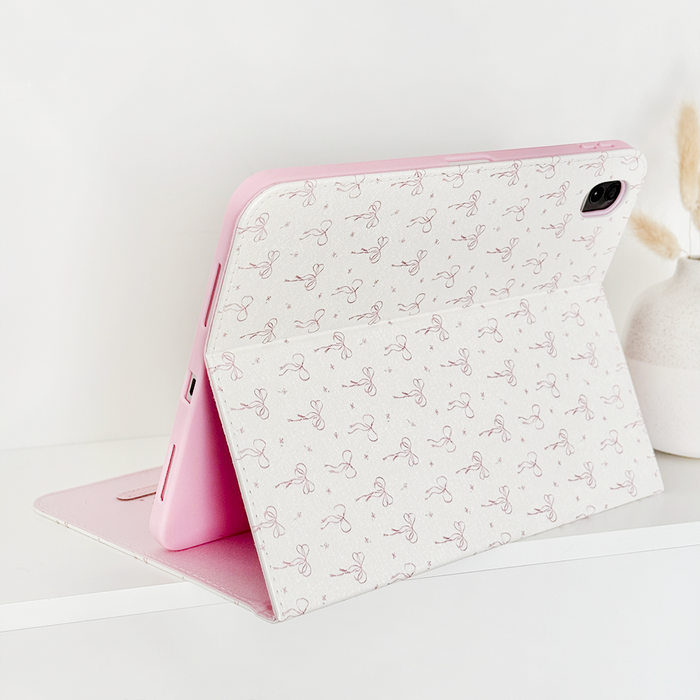 Pink iPad case with a white floral-patterned cover, designed by Coconut Lane.