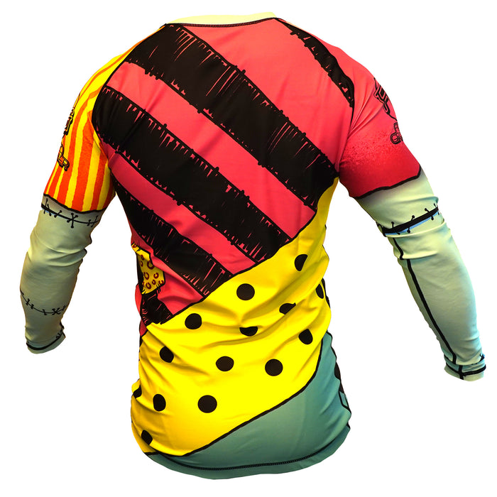 The Retro Grappler Doll Face Nightmare Before Christmas BJJ Rash Guard is a long-sleeve top with a colorful patchwork design—black stripes, yellow polka dots, bold red, orange, and teal sections—resembling a whimsical costume when viewed from the back.