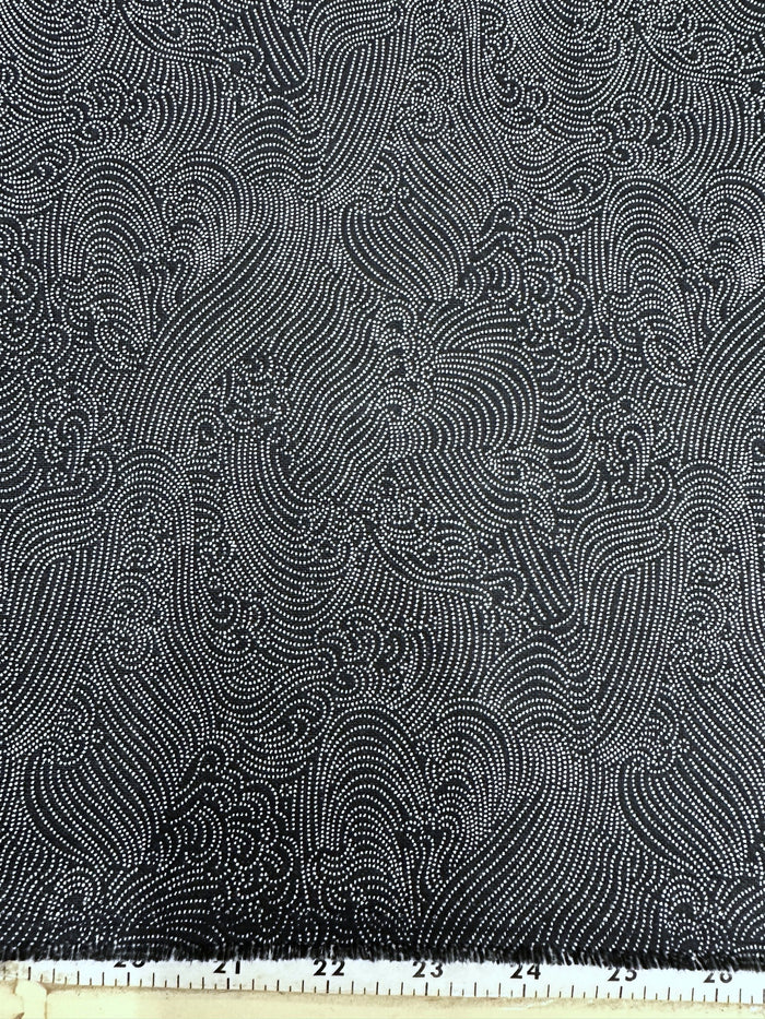 navy and white patterned fabric with a ruler at the bottom for scale.
