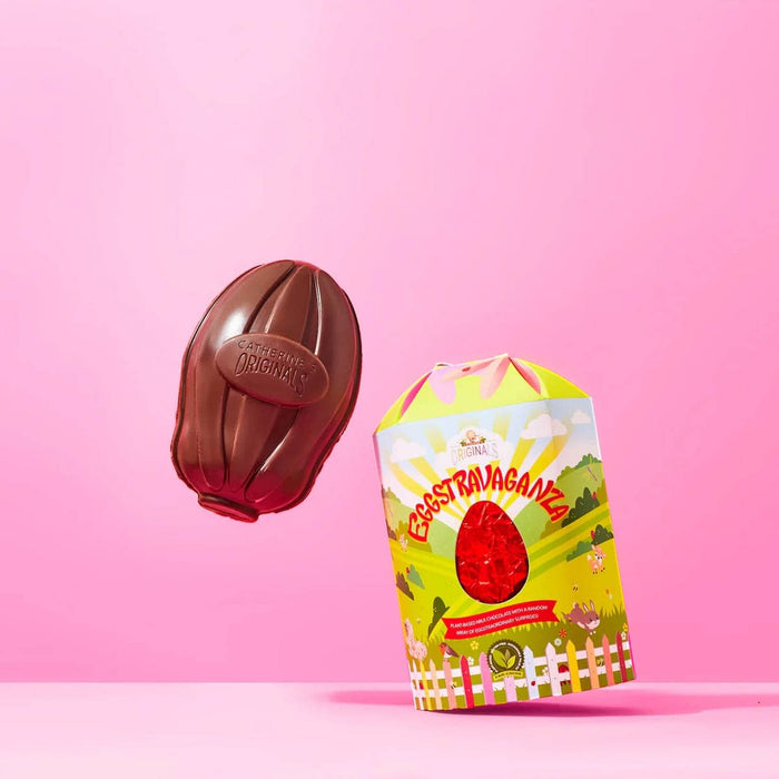 Chocolate egg and its packaging on a pink background.