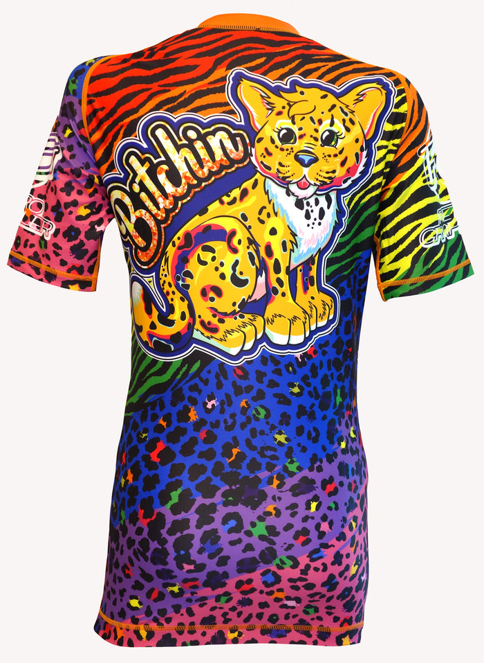 The Face Crank 2 - Lisa Frank Parody BJJ Rash Guard by Retro Grappler is a colorful women’s top with a bold cartoon leopard, Bitchin text, and eye-catching rainbow animal print in red, orange, green, blue, purple, and black.