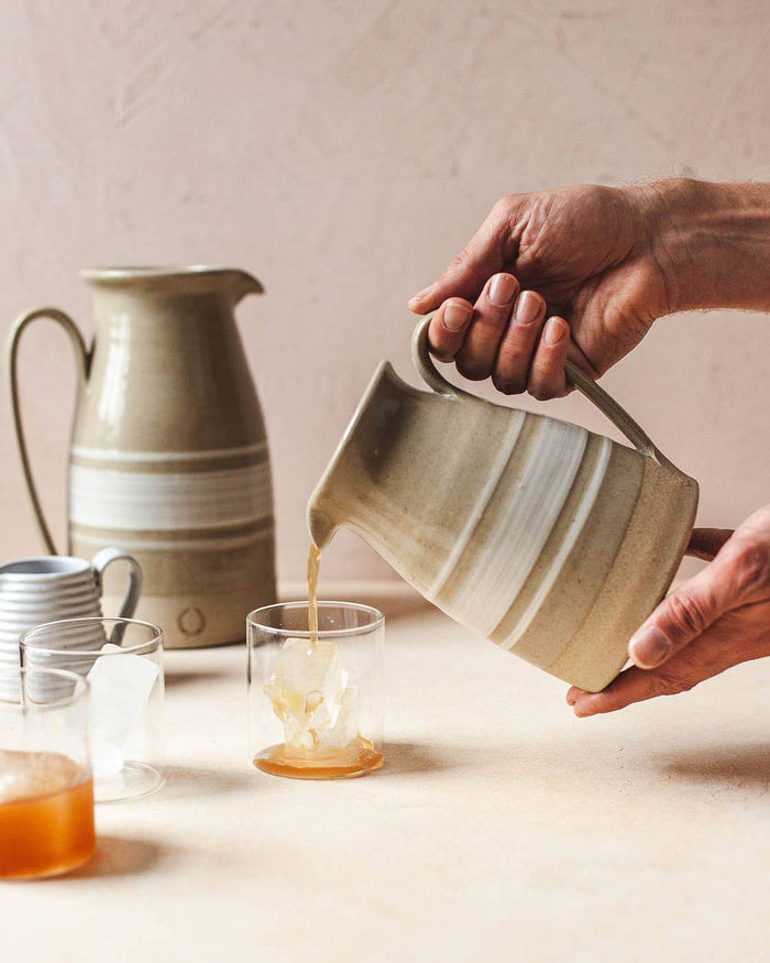 Farmhouse Yellowware Stoneware Pitcher — pouring a drink into glassware; Farmhouse Pottery