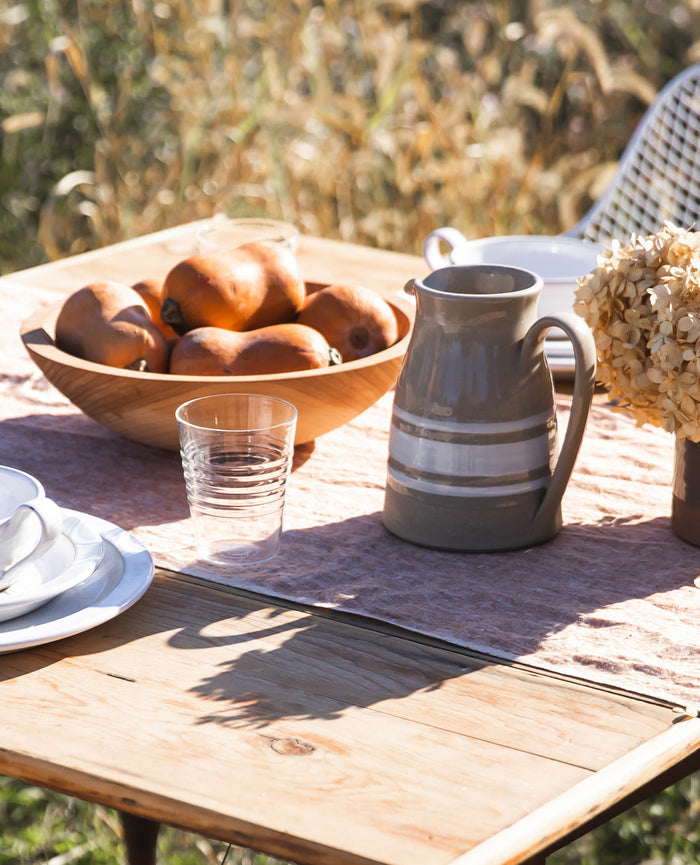 Farmhouse Yellowware Stoneware Pitcher — pitcher at an outdoor table; Farmhouse Pottery