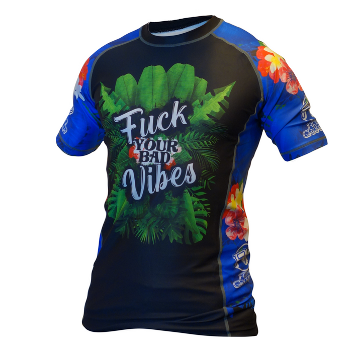 The Retro Grappler F#@k your Bad Vibes BJJ Rash Guard features blue short sleeves, floral details, and green tropical leaves. F#@k your Bad Vibes is boldly printed—ideal for MMA or jiu jitsu training sessions.