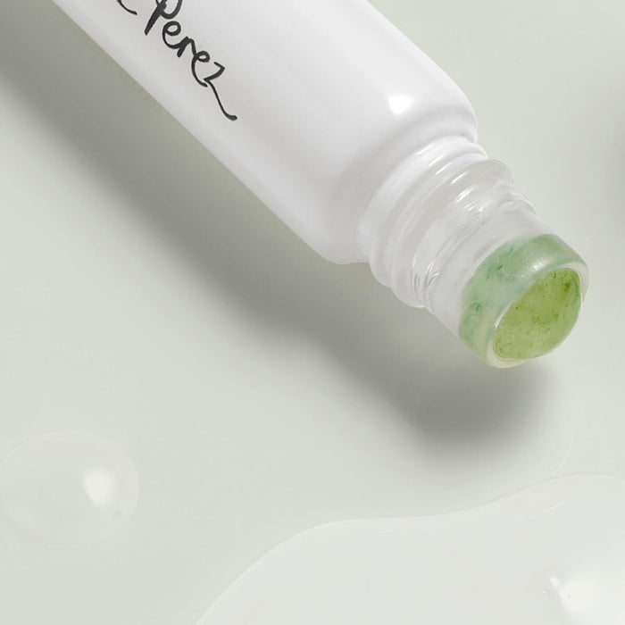 Closeup of Ere Perez Grape Water Eye Serum with a jade roller applicator.