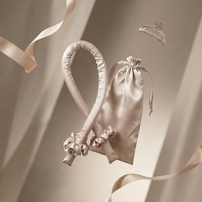 The Olla Bella Heatless Curling Headband and Satin Bag kit displayed on a background of flowing satin and ribbons.