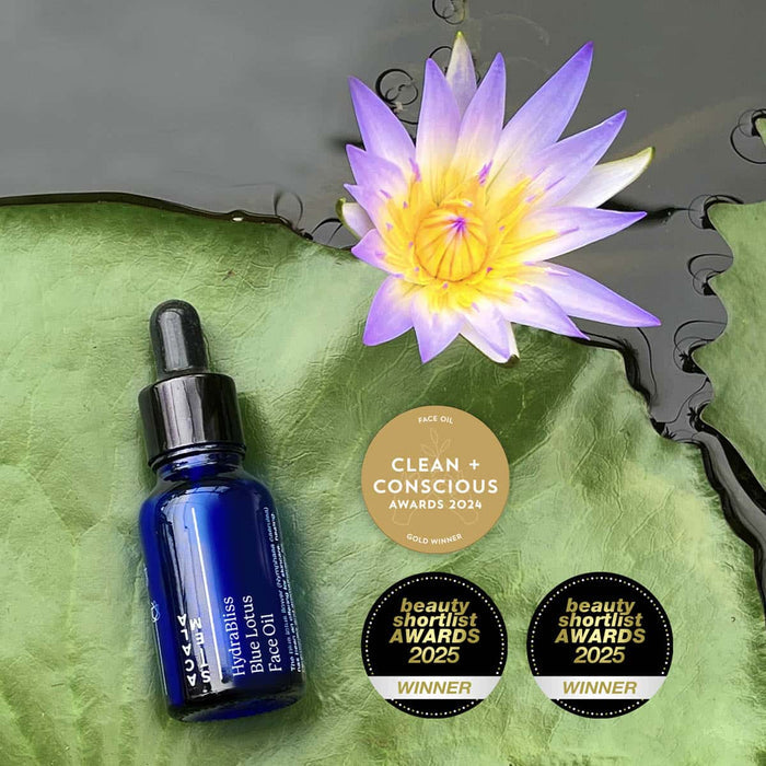 Blue lotus face oil on a lotus leaf in a pond.  Clean + Conscious awards 2024 gold winner.