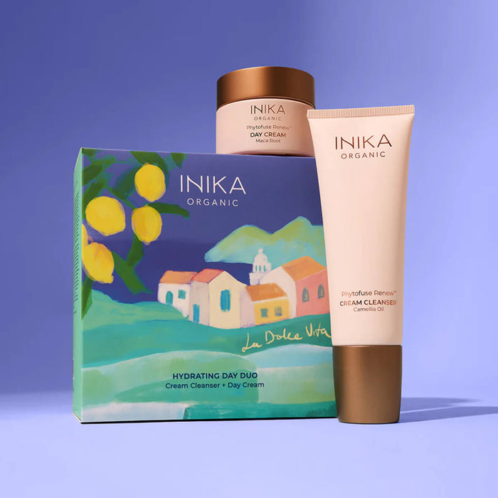 INIKA Organic skincare products including a cream cleanser and day cream on a blue background.