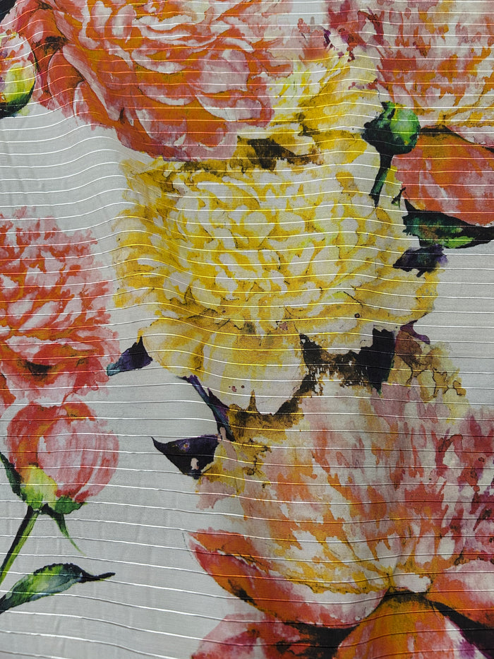 Close-up of a floral pattern with yellow, pink, and orange flowers on a white background.