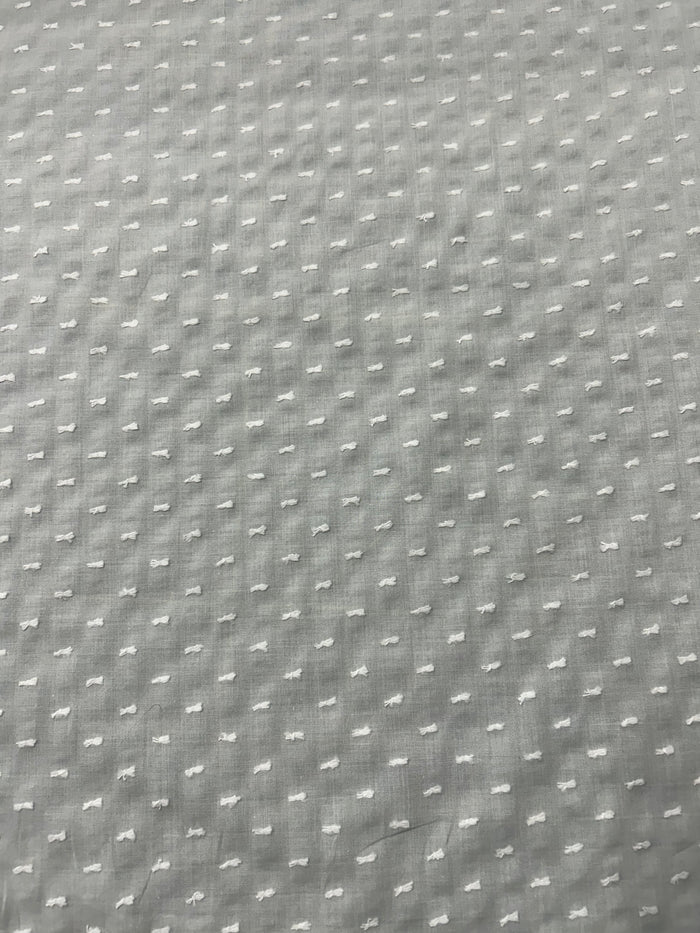 Close-up of white swiss dot fabric.with