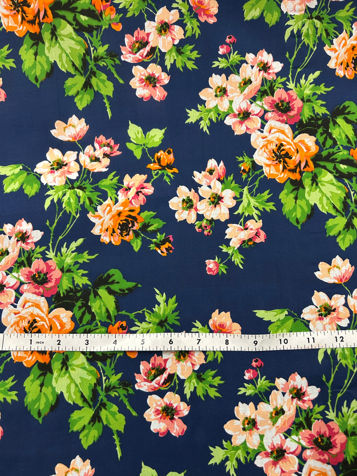 Floral fabric pattern with a measuring tape at the bottom on a navy background
