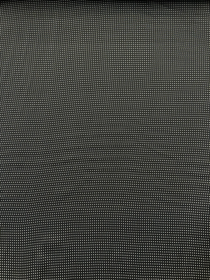 Close-up of a mini black and white polka dot fabric.