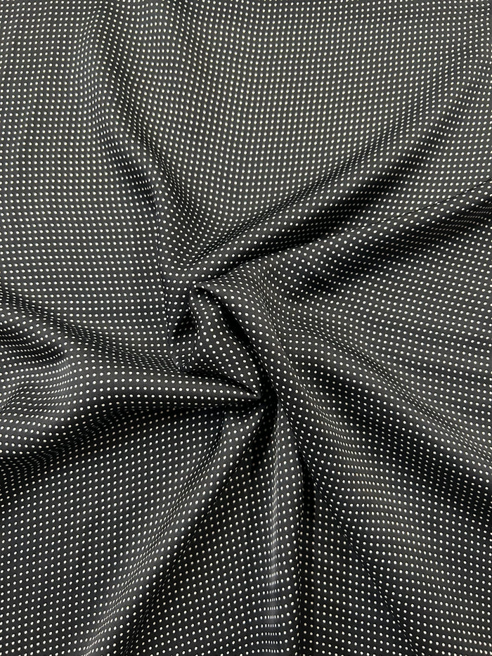 Close-up mini black and white polka dot fabric.
