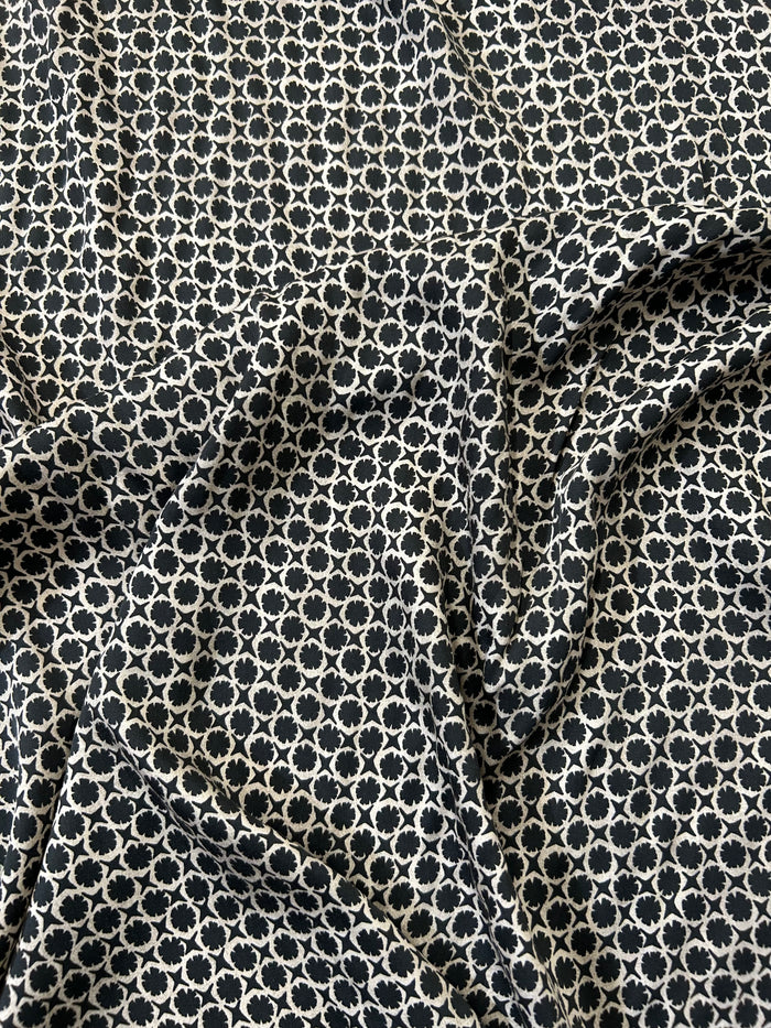 vintage-style, black and tan geometric print, made of viscose with a satin finish draped.